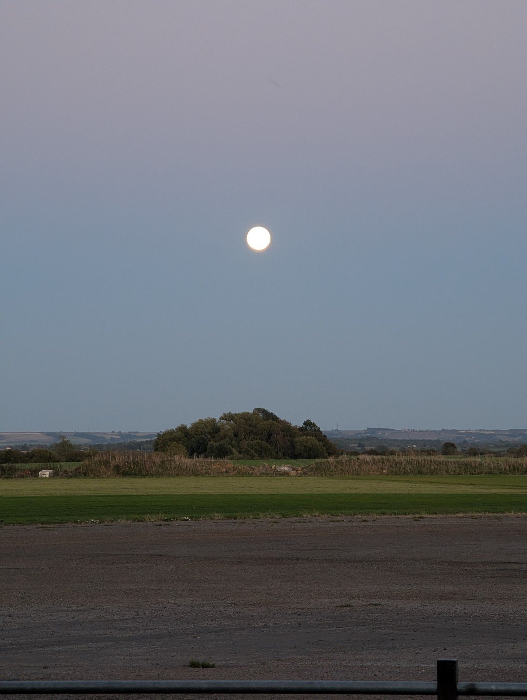the moon over an airfield