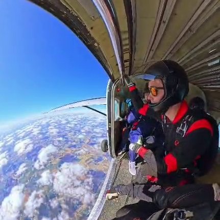 me looking out of the door of a plane